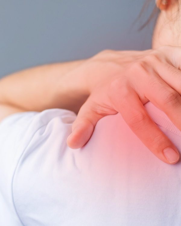 woman with her shoulder sprain, muscle painful during overwork. Girl having body problem after wake up. Shoulder ache, Scapular pain, office syndrome and ergonomic concept